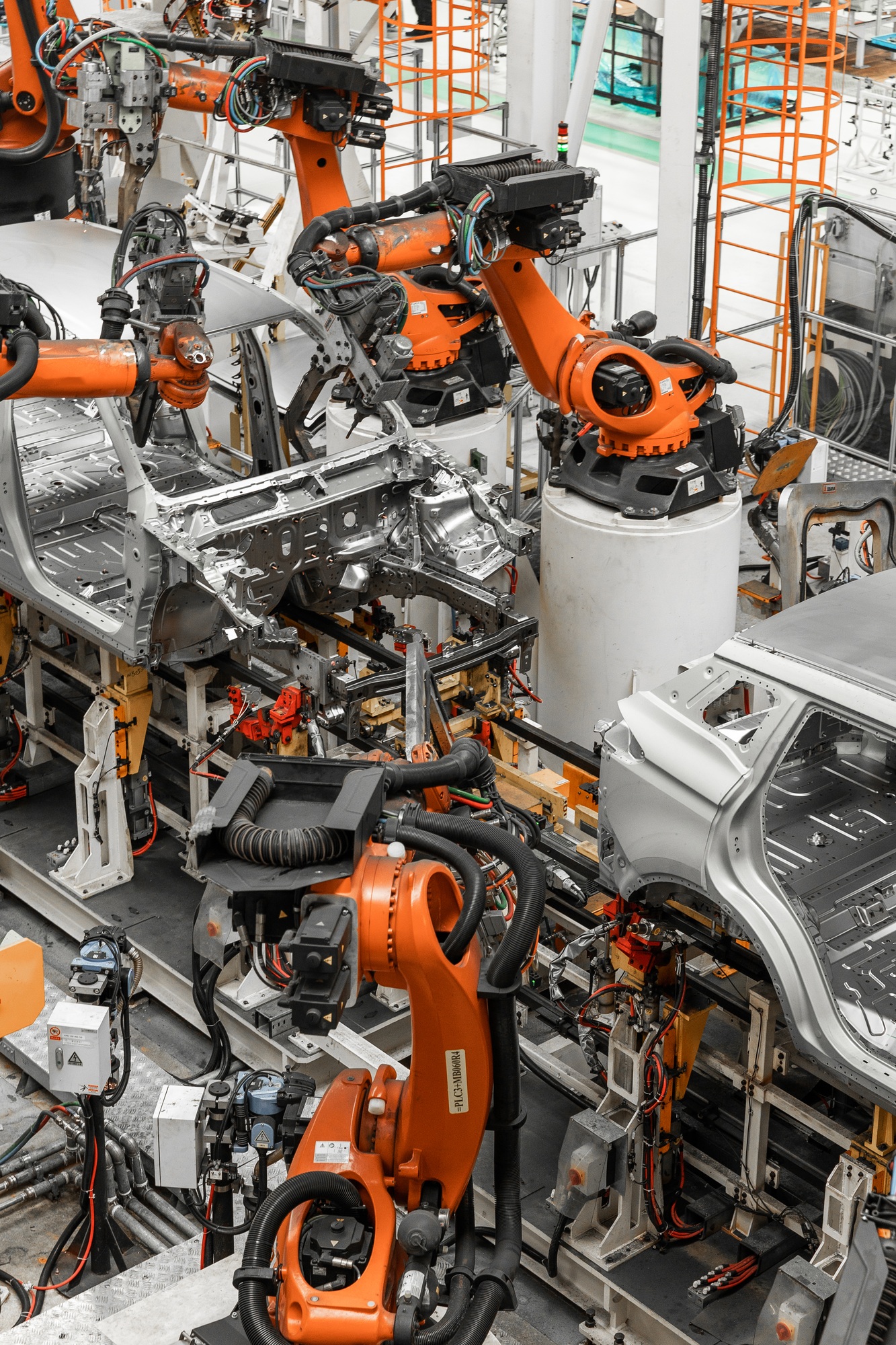 Vertical photo of automobile production line. Modern car assembly plant. Auto industry. Interior of